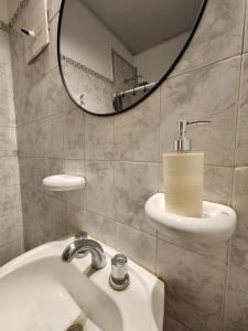 a bathroom with a sink and a mirror at Tribunales in Junín