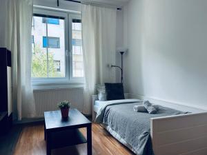 a bedroom with a bed and a window and a table at Sweet Dreams - cozy Stay in city center in Bratislava