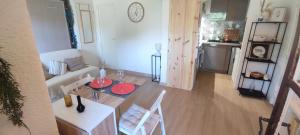 a living room with a couch and a table at Charmant studio proche mer avec piscine in Les Issambres