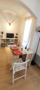 a living room with a table and a chair at Charmant studio proche mer avec piscine in Les Issambres