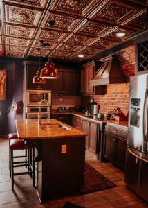 a kitchen with wooden cabinets and a kitchen island at Broadway 4br 2bth 2500sf Art Gallery and Steam Room in Nashville