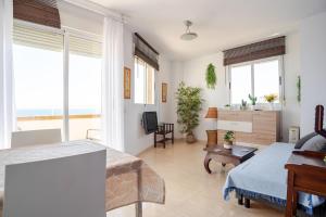 a bedroom with a bed and a living room with windows at Vistas Mágicas Mar Mediterraneo in Oropesa del Mar