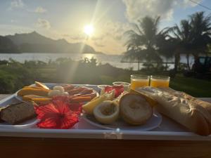a plate of food on a table with orange juice at Maroe Bay Lodge in HUH