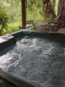 a hot tub in the middle of a yard at Chase's River Cabin - Hot-tub Firepit & Fireplace in Granite Falls