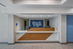 an empty lobby of an office with a reception desk at Holiday Inn Express San Diego - Sorrento Valley by IHG in Sorrento +29 photos