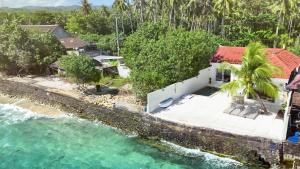 an aerial view of a house next to the water at Amada Penida Villa in Nusa Penida