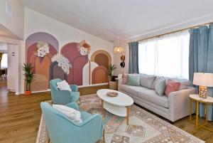 a living room with a couch and chairs and a table at Desert Dream Oasis - Spa, Cabana, Firepit, Disney and Hulu in Yucca Valley