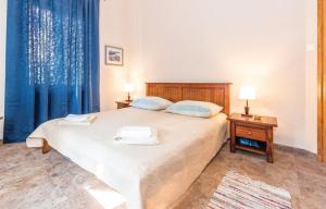 a bedroom with a large bed with blue curtains at Seaside holiday house Jadrija, Sibenik - 24454 in Jadrija