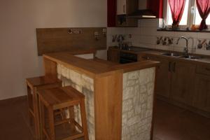 a kitchen with a wooden island in the middle at Seaside holiday house Jadrija, Sibenik - 24454 in Jadrija +14 photos