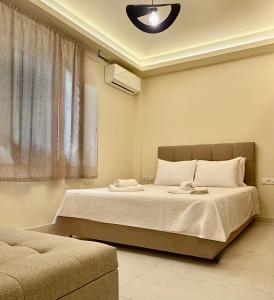 a bedroom with a bed and a couch at GK Luxury Suites in Alexandroupoli
