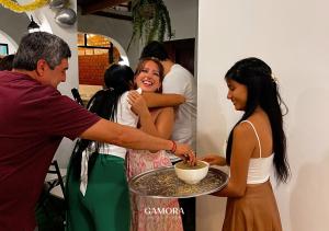 a man serving a bowl of food to two girls at Gamora Hotel Playa in Los Órganos +138 photos