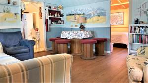 a living room with a table and some chairs at Little Sandpiper in Cape May Point