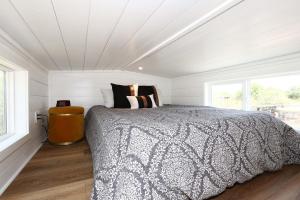 a bedroom with a large bed in a white room at Horseshoe Tiny home in Scottsdale +46 photos