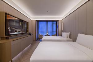 Ένα ή περισσότερα κρεβάτια σε δωμάτιο στο Crystal Orange Shanghai Lujiazui Financial Center Hotel