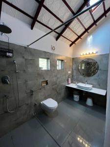 a bathroom with a toilet and a sink and a shower at Birdsong Coffee Estate Stay in Madikeri +25 photos
