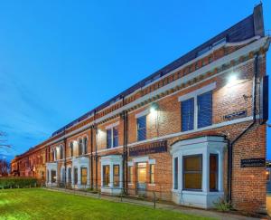 a brick building with a lawn in front of it at Grainger Hotel in Newcastle upon Tyne