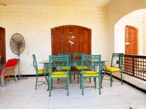 a green table and chairs on a patio at Marina 5 مارينا in El Alamein