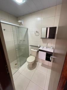 a bathroom with a toilet and a shower and a sink at Casa Paris in Caruaru