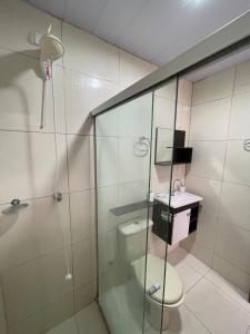 a bathroom with a shower with a toilet and a sink at Casa Paris in Caruaru