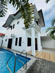 a house with a swimming pool in front of it at 4 bedroom with big pool villa near clark in Sampong +17 photos
