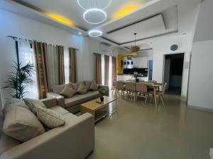 a living room with a couch and a table at 4 bedroom with big pool villa near clark in Sampong