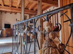 a wrought iron fence with baskets on it at Gîte charmant avec jardin privatif, proche sites historiques et activités de plein air - FR-1-496-183 in Cuinzier