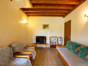 a living room with two couches and a tv at Maison familiale avec terrasse et jardin clos près de Belvès - FR-1-616-9 in Bouillac