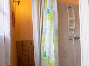 a shower curtain in a bathroom next to a door at Maison confortable près de Périgueux avec cheminée, jardin et animaux admis - FR-1-616-10 in Bassillac