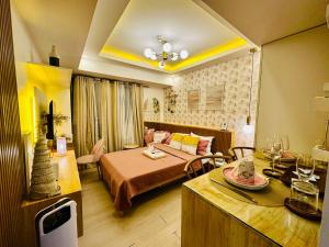 a living room with a bed and a dining room at Chic Hideaway at Azure North Bali Tower in San Fernando