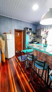 a kitchen with a table and chairs and a refrigerator at Hospedagem Don Panizzi in Bento Gonçalves +19 photos