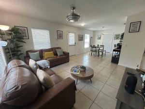a living room with a couch and a table at Tropical 3bed 2bath Lakeland Home on corner lot in Lakeland