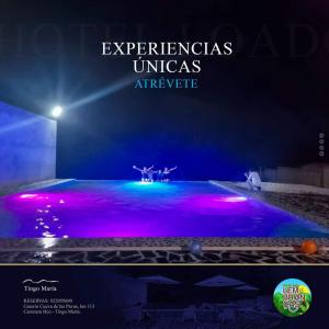 a stage with purple and blue lights on it at LEMBRANÇAS HOTEL LODGE in Tingo María +2 photos