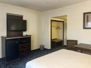 a hotel room with a bed and a flat screen tv at Oceanside, CA – Marina / Camp Pendleton in Oceanside