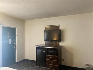 a room with a flat screen tv on top of a cabinet at Oceanside, CA – Marina / Camp Pendleton in Oceanside