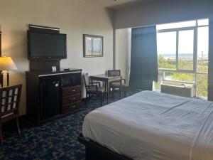 a hotel room with a bed and a flat screen tv at Oceanside, CA – Marina / Camp Pendleton in Oceanside