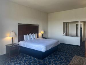 a hotel room with a large bed and two lamps at Oceanside, CA – Marina / Camp Pendleton in Oceanside