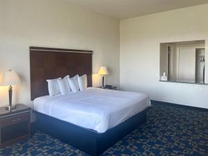 a hotel room with a large bed and two lamps at Oceanside, CA – Marina / Camp Pendleton in Oceanside
