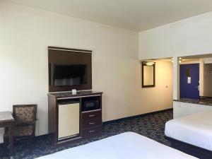 a hotel room with a bed and a flat screen tv at Oceanside, CA – Marina / Camp Pendleton in Oceanside