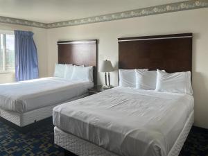 a hotel room with two beds with white sheets at Oceanside, CA – Marina / Camp Pendleton in Oceanside