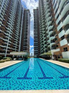 a swimming pool in front of some tall buildings at The Radiance Manila Bay in Sampong