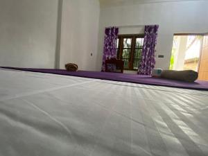 Rúm í herbergi á One FS Hotel Arugambay