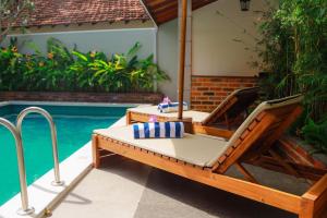 a bed sitting next to a swimming pool at Moana La Vie - Polhena in Matara +22 photos
