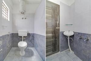 a bathroom with a toilet and a sink at Hotel O GN Nelli Suites in Bengaluru