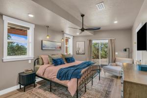 a bedroom with a bed with blue pillows at Twilight Ridge Zion Basecamp with All the Extras in Orderville