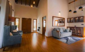 a living room with two chairs and a couch at Moana La Vie - Polhena in Matara