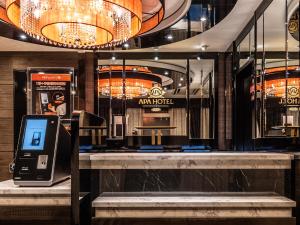 a lobby with a counter with a cell phone in it at APA Hotel Nambaminami Daikokucho Ekimae in Osaka