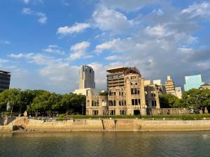 a building next to a body of water at Rihga Royal Hotel Hiroshima in Hiroshima