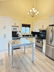 a kitchen with a table in the middle of it at Gorgeous House&30 second Bus station Close C-Train& Free Parking in Calgary