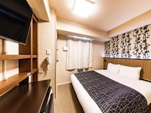 Postel nebo postele na pokoji v ubytování APA Hotel Nambaminami Daikokucho Ekimae