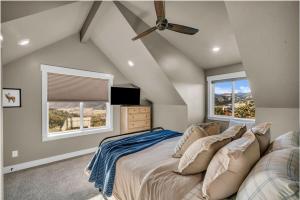 a bedroom with a bed and two windows at Cactus Canyon Retreat Zion Base Hot Tub View in Orderville +22 photos
